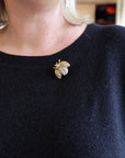 Navy sweater with a decorative brooch