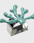 A set of coral-shaped napkin rings with turquoise color and pearl inlay