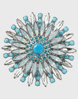 A turquoise and clear crystal flower-shaped napkin ring.