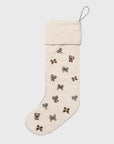 Beige Christmas stocking with decorative bows on a white background