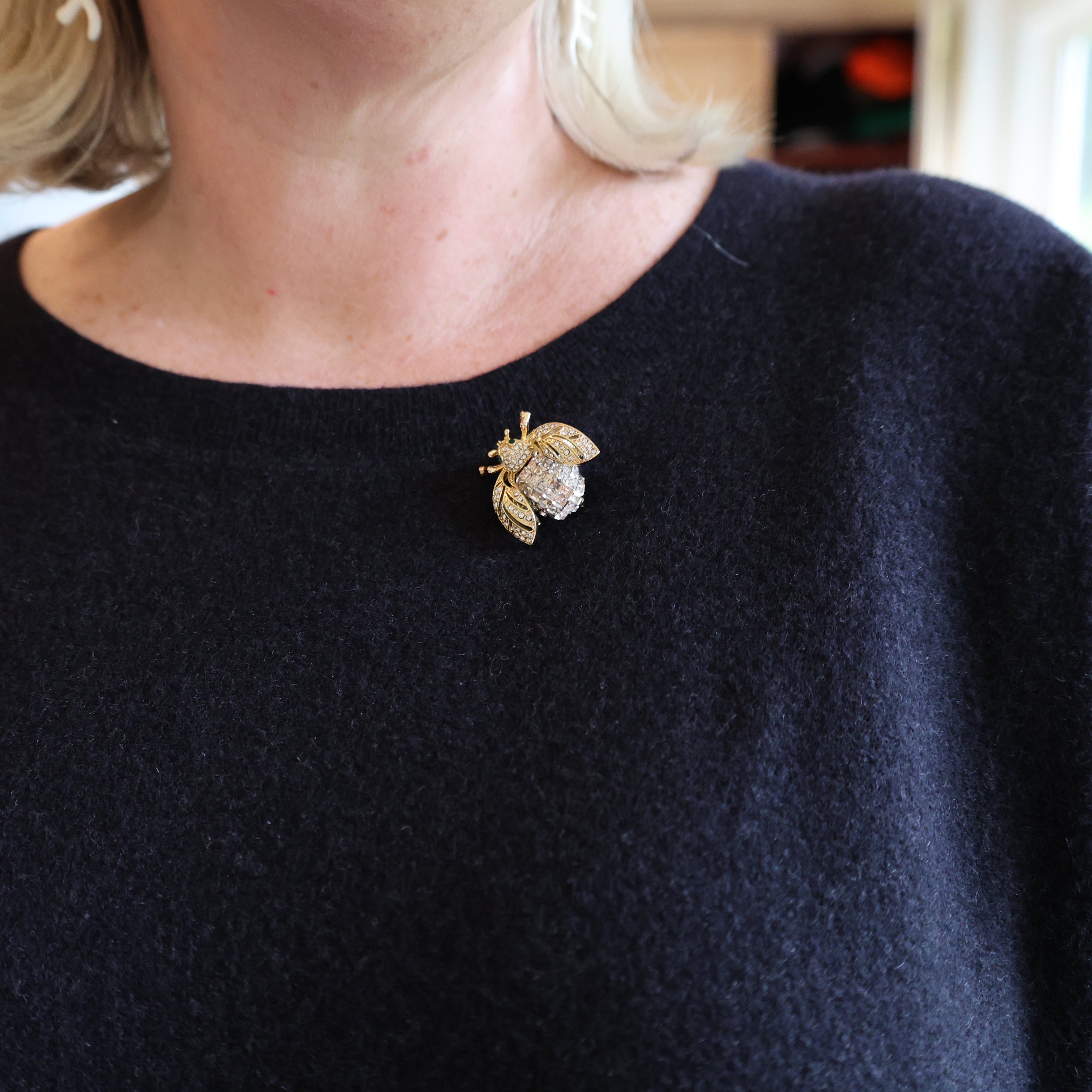 Navy sweater with a decorative brooch