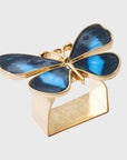A gold-colored napkin ring featuring a blue butterfly design on top.