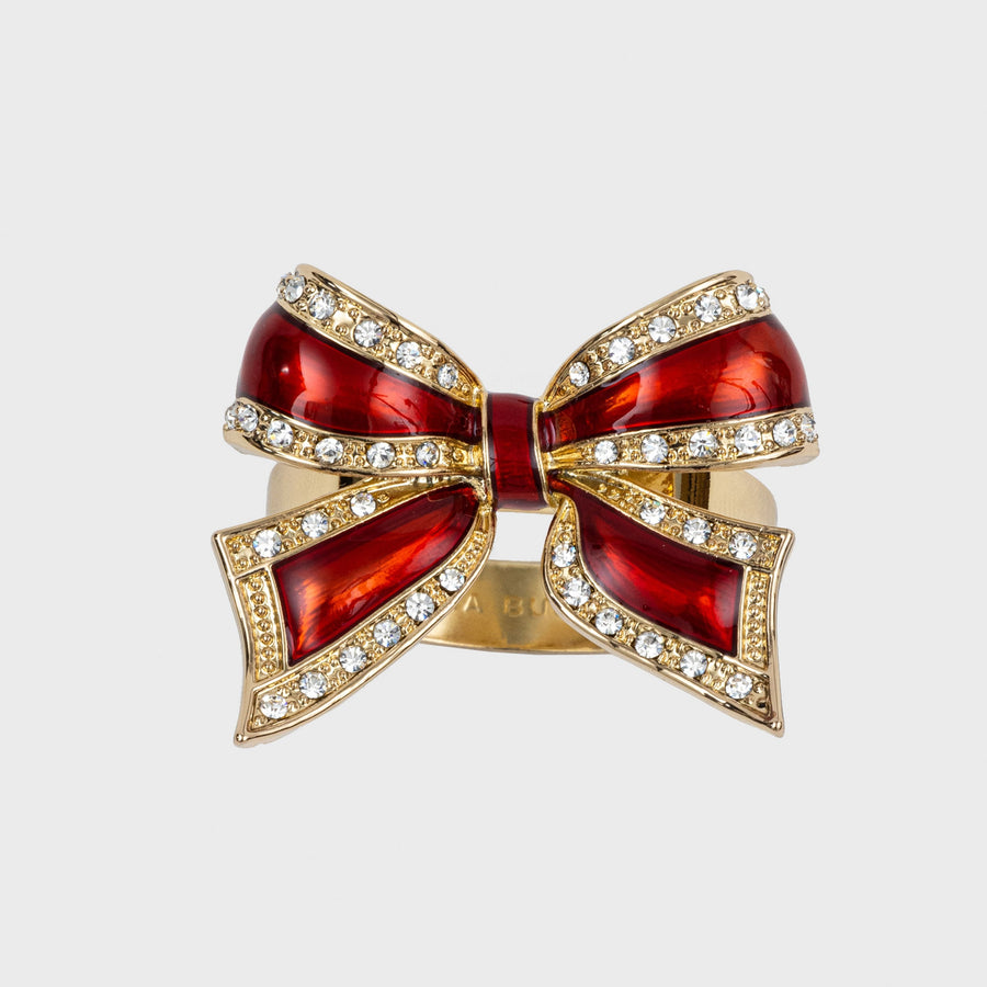 A red and gold bow-shaped napkin ring with rhinestone embellishments.
