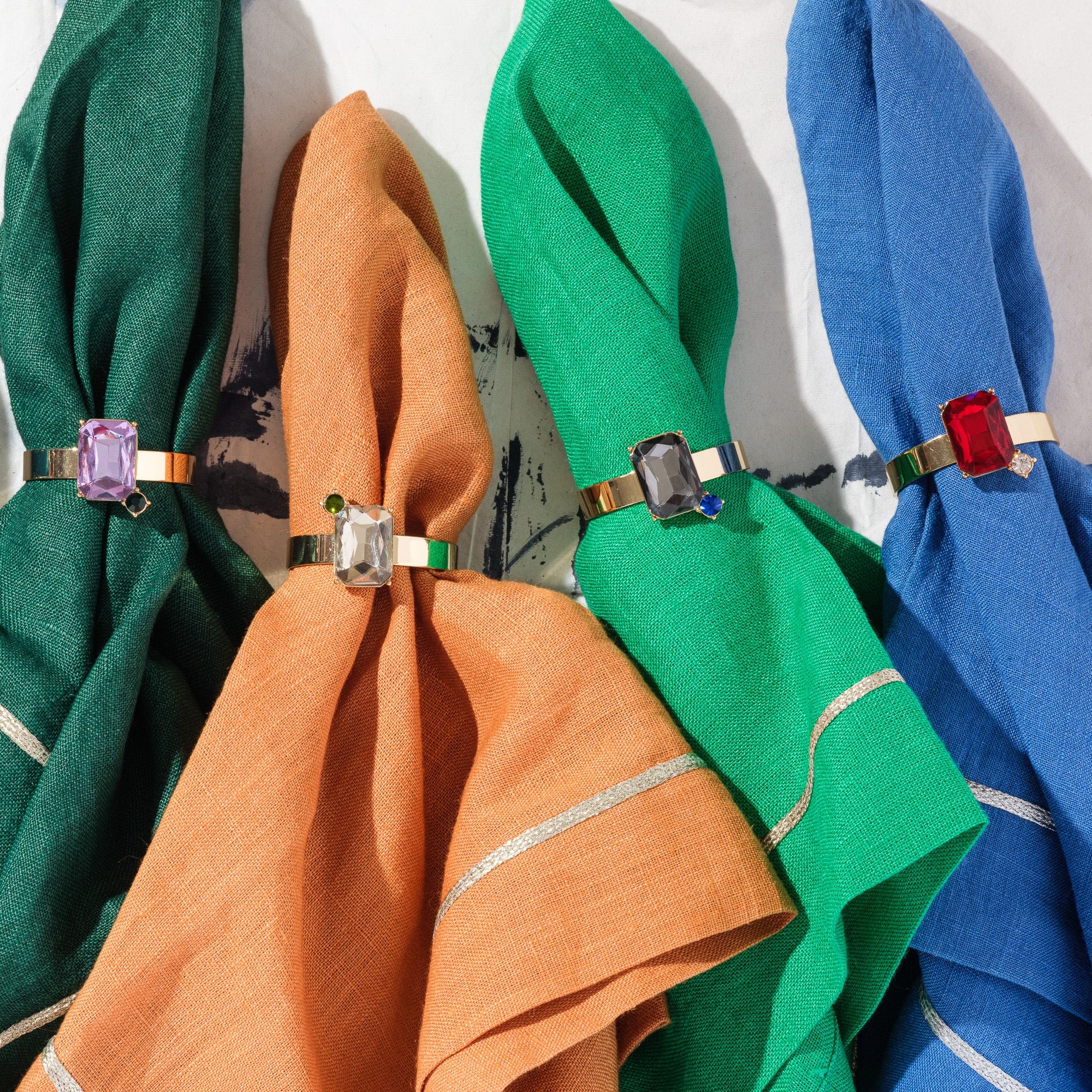Colorful napkins with decorative rings on a white background