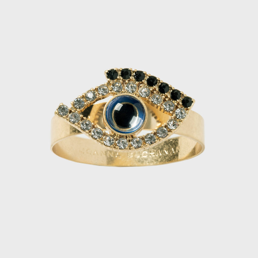 A skinny band napkin ring featuring a crystal-embellished eye design in gold color.