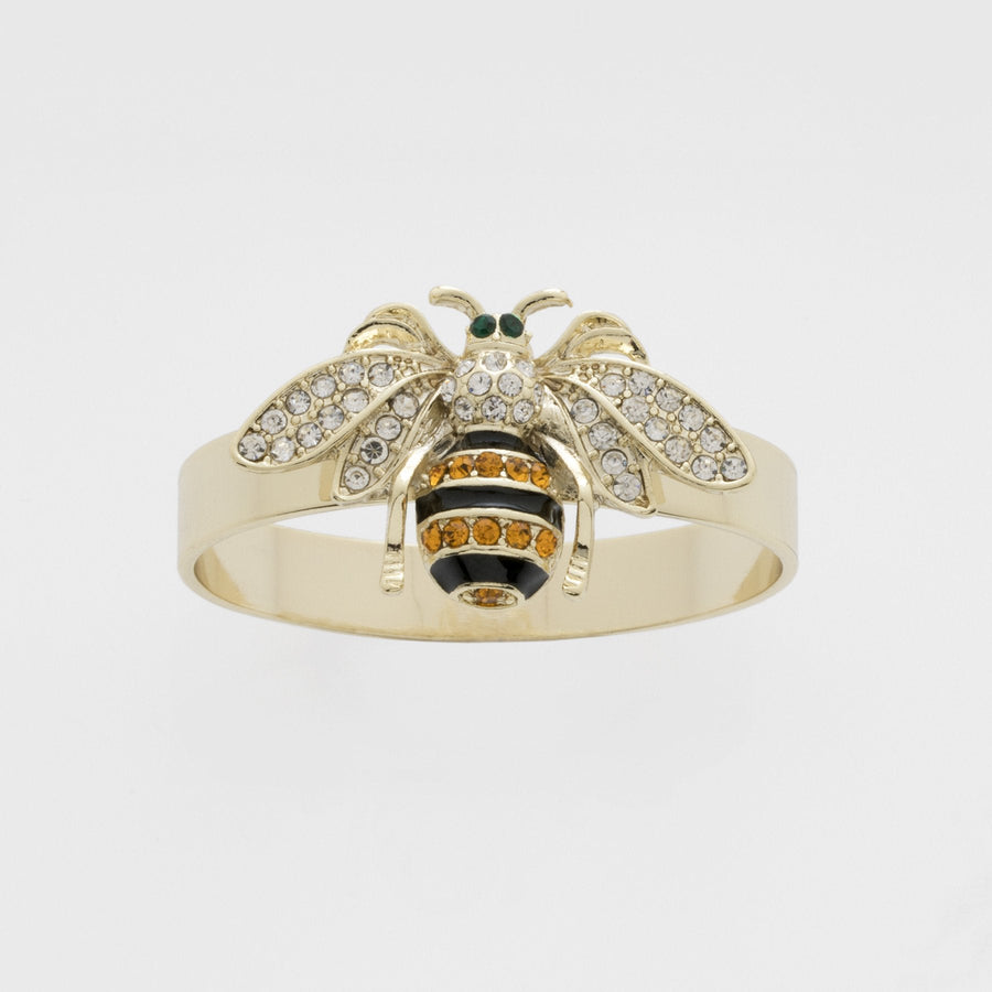 A gold-colored napkin ring featuring a skinny stripey bee design with black, white, and orange details.