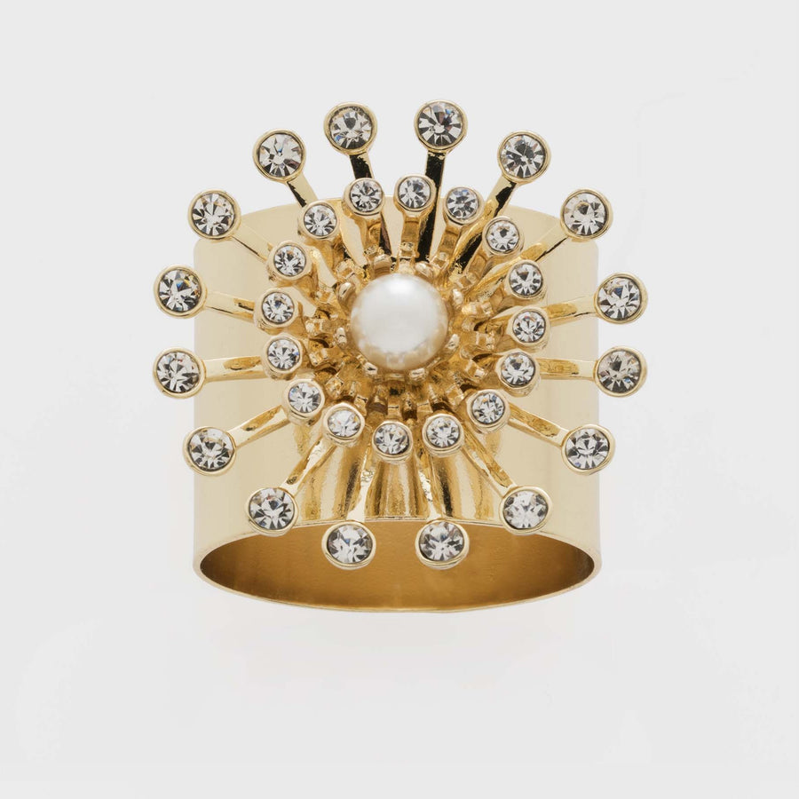 A gold-colored napkin ring featuring a faux pearl at the center with sparkling crystals radiating outward.