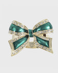 A green and gold enamel bow napkin ring with rhinestone accents.
