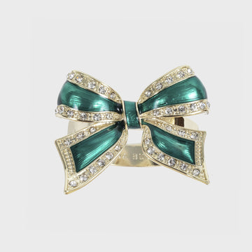 A green and gold enamel bow napkin ring with rhinestone accents.