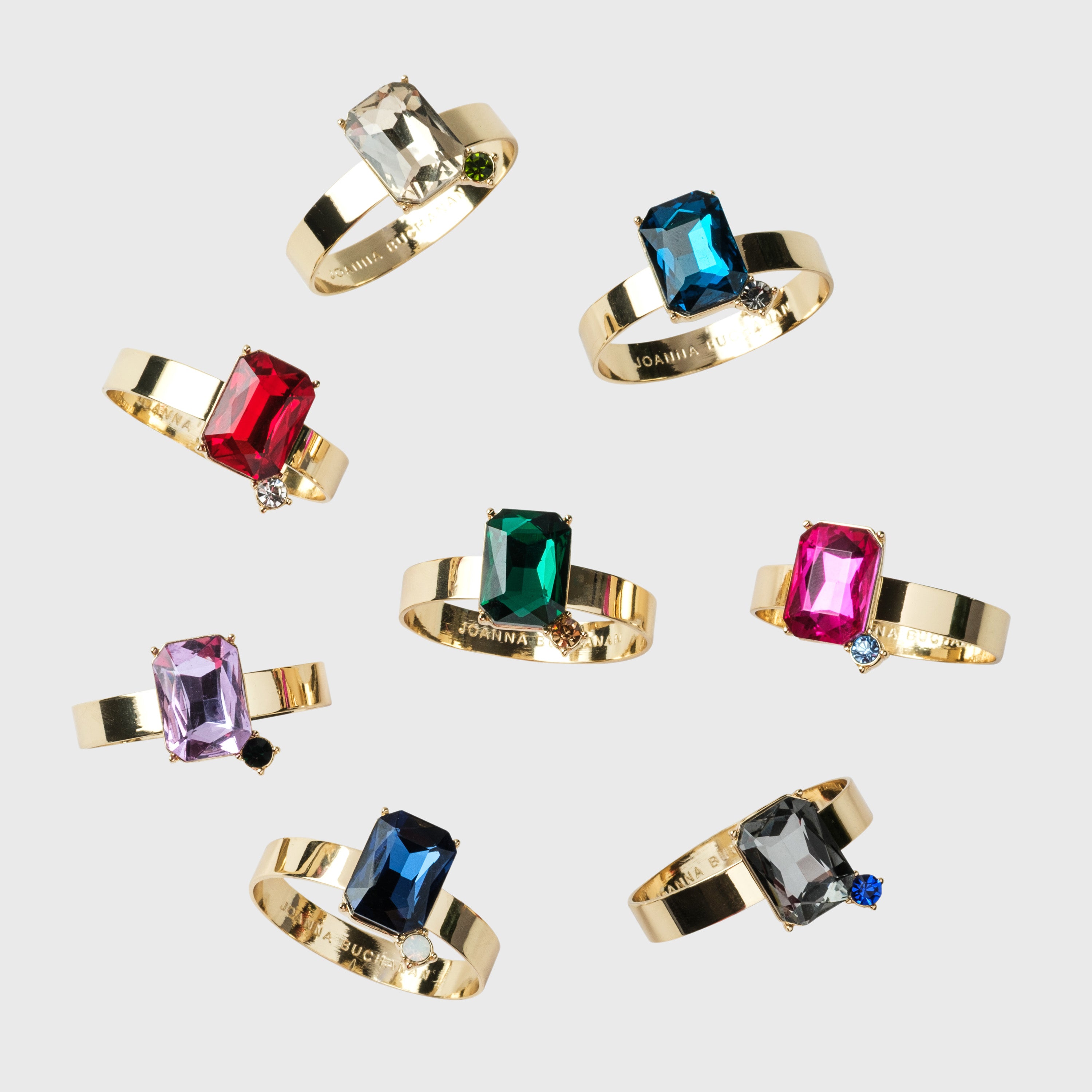 Gold napkin rings with colorful gemstones 