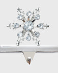 A silver snowflake stocking hanger with crystal embellishments.