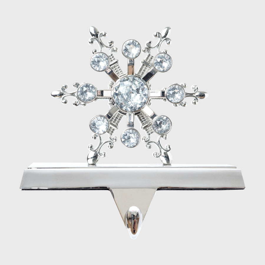 A silver snowflake stocking hanger with crystal embellishments.