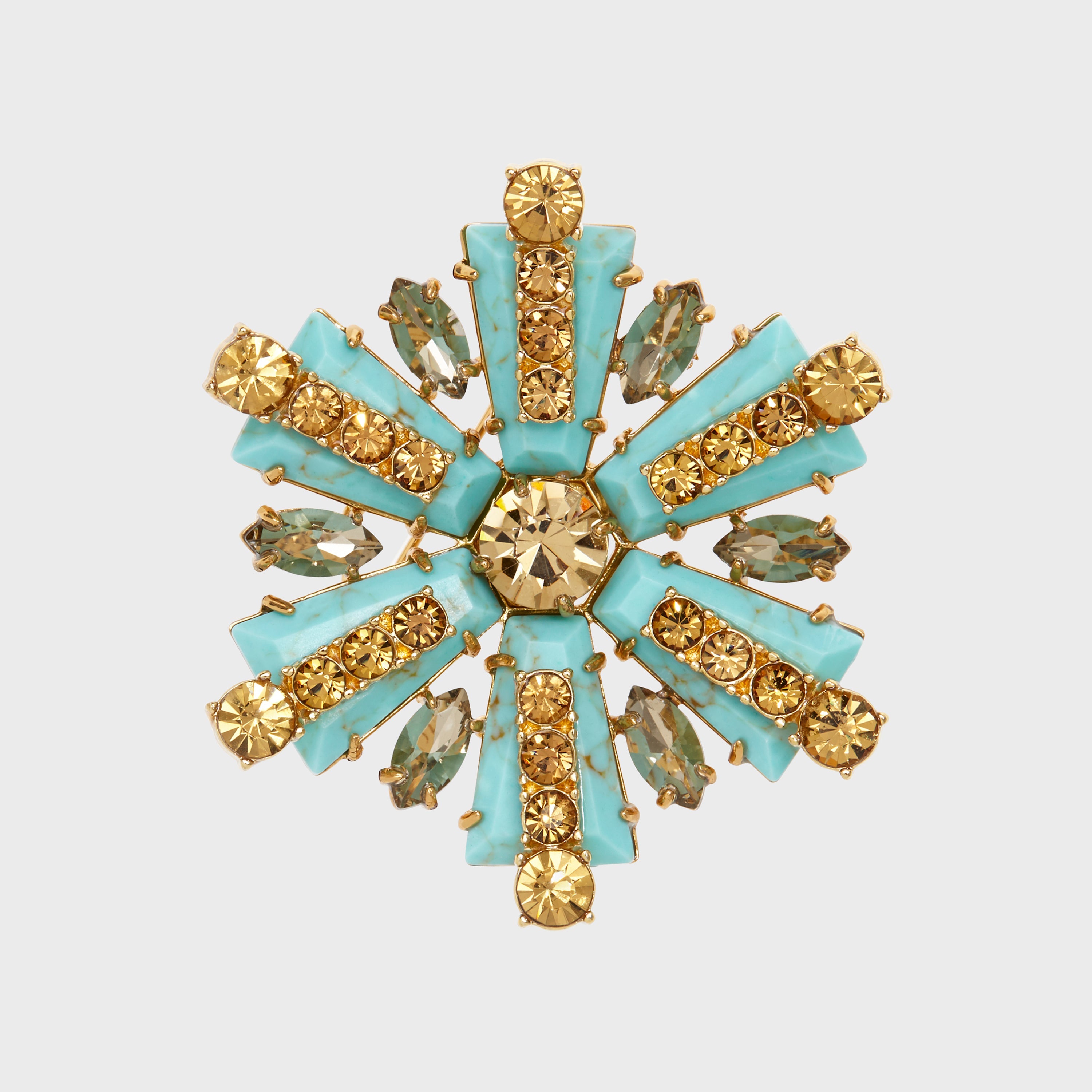A star-shaped brooch with turquoise and gold-colored stones