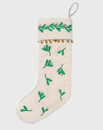 Christmas stocking with green leaf patterns on a white background