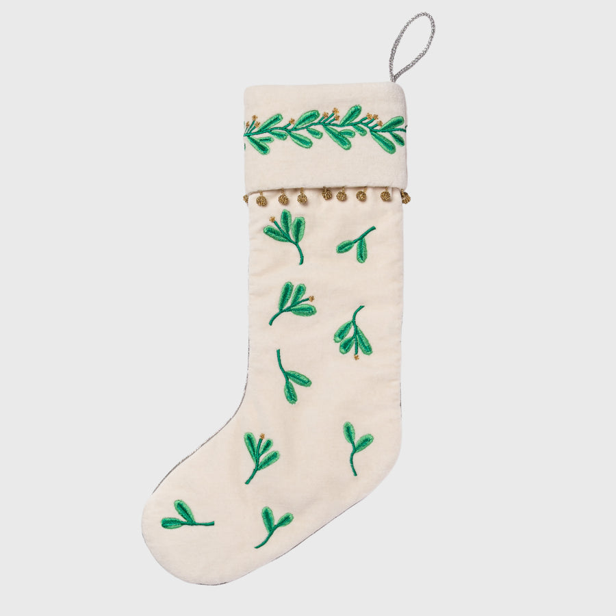 Christmas stocking with green leaf patterns on a white background