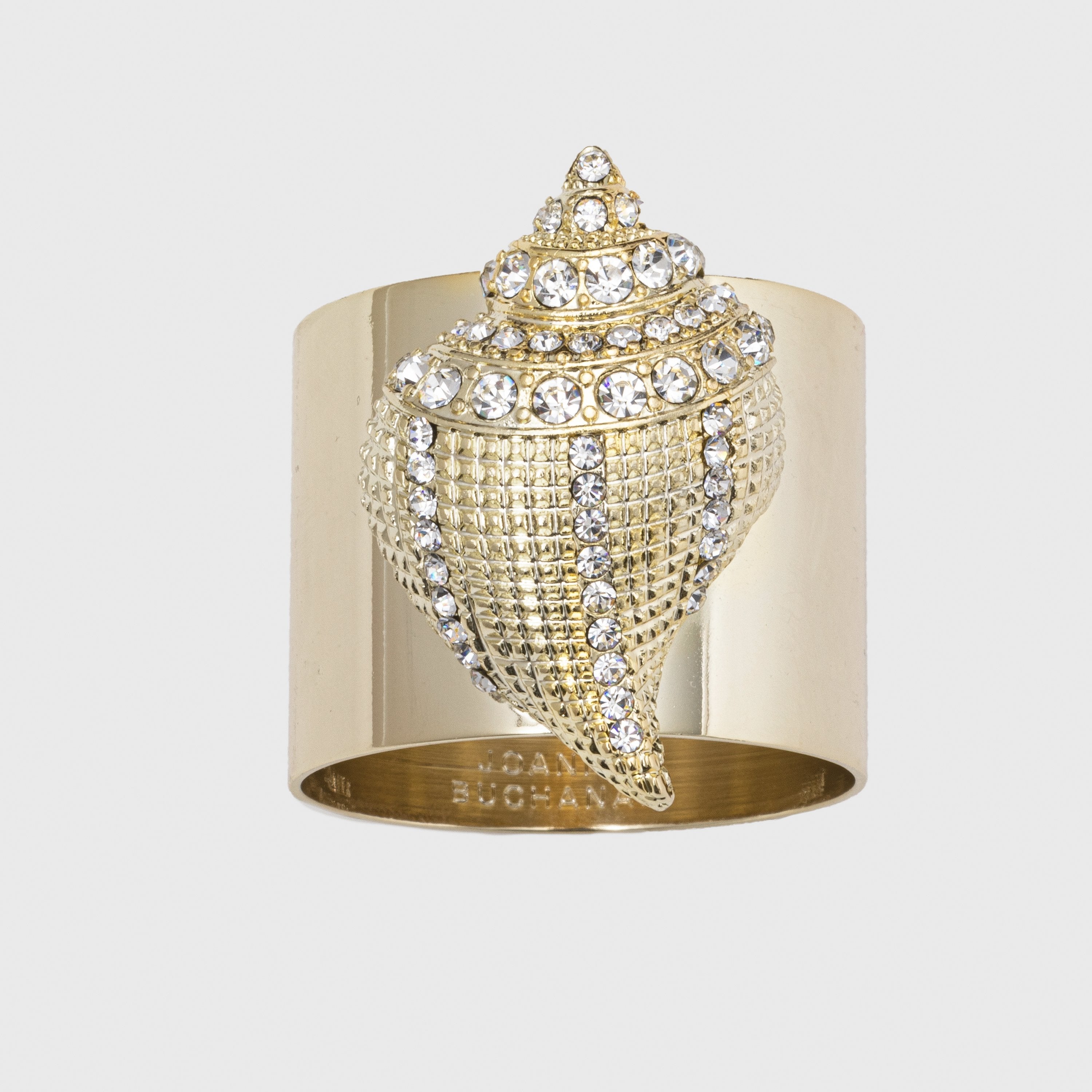 A gold-colored napkin ring featuring a seashell design with sparkle embellishments.