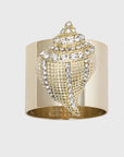 A gold-colored napkin ring featuring a seashell design with sparkle embellishments.
