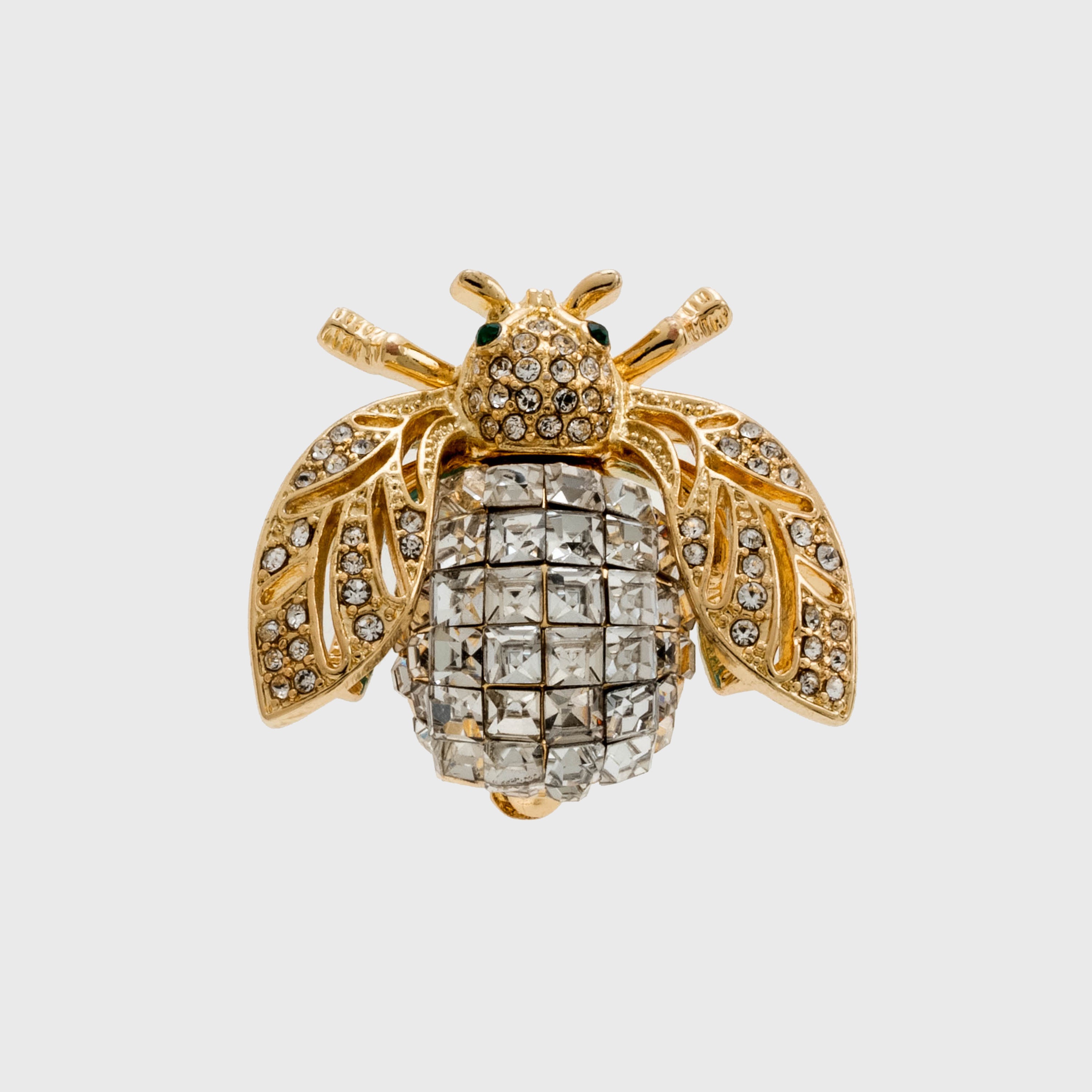 A gold-colored brooch shaped like a bee, adorned with sparkling crystals.