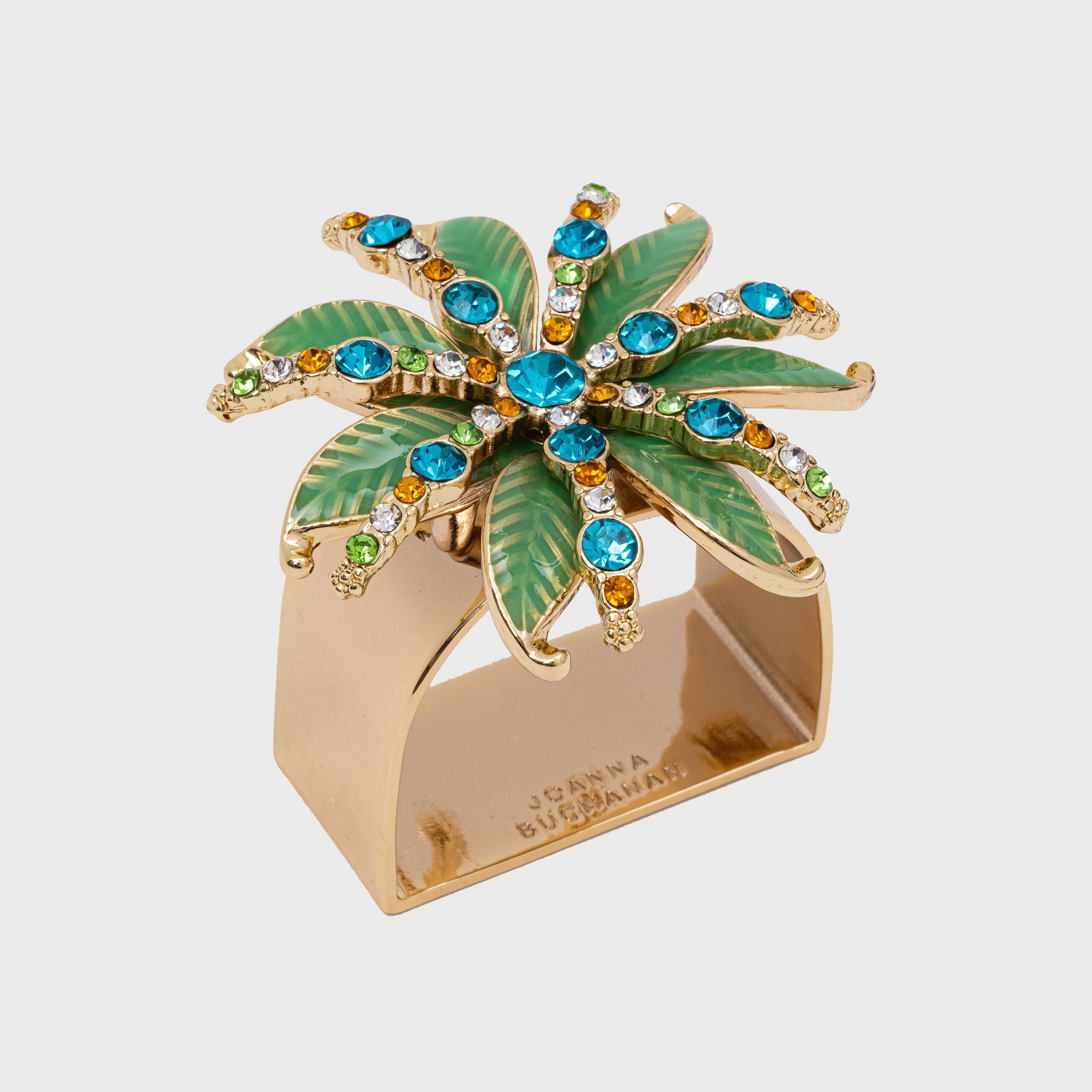 A gold-colored napkin ring featuring a green and jeweled palm ornament.