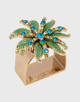 A gold-colored napkin ring featuring a green and jeweled palm ornament.