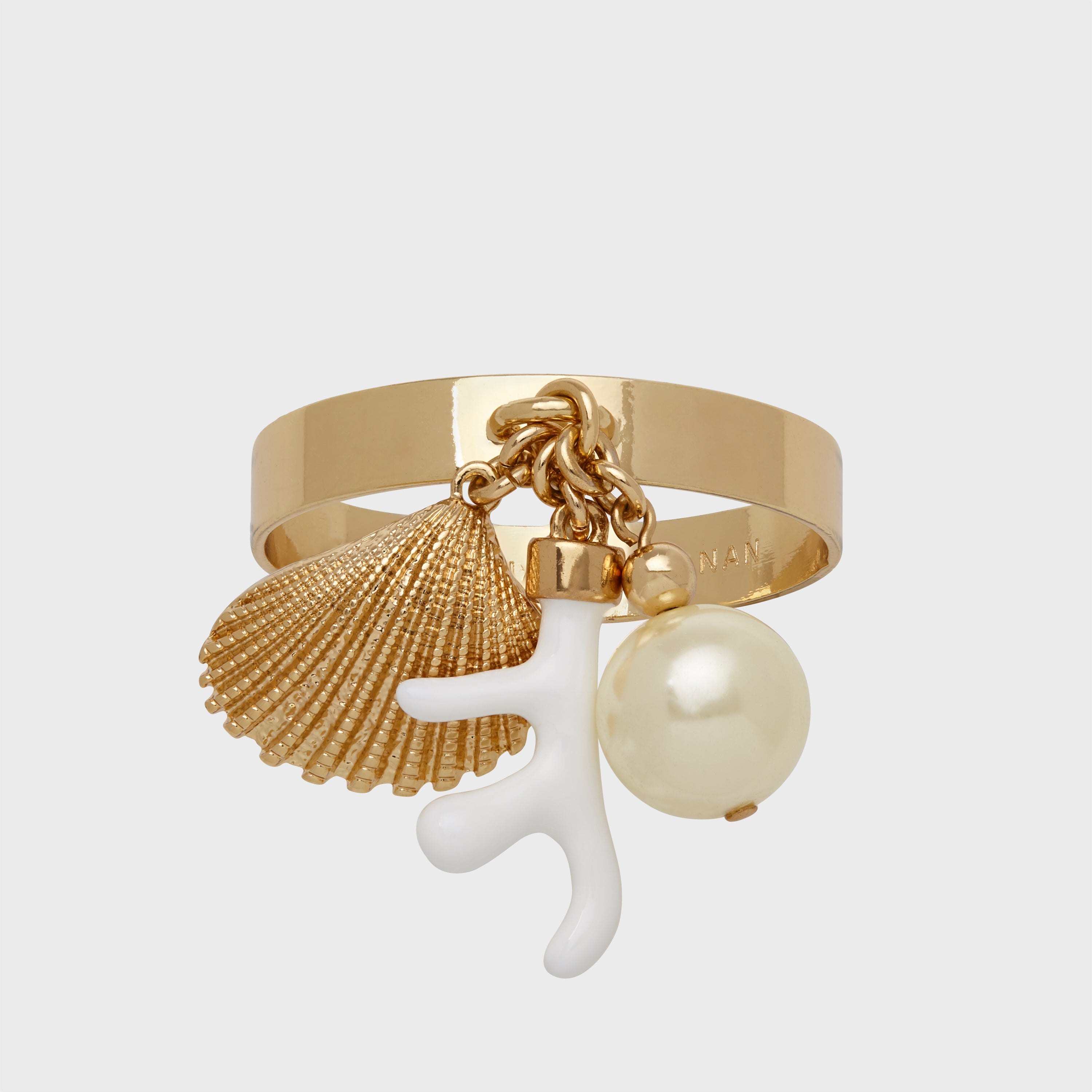 A gold-colored napkin ring featuring dangling coral and shell charms with a pearl-like element.