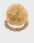 A beige pompom napkin ring made of straw, 