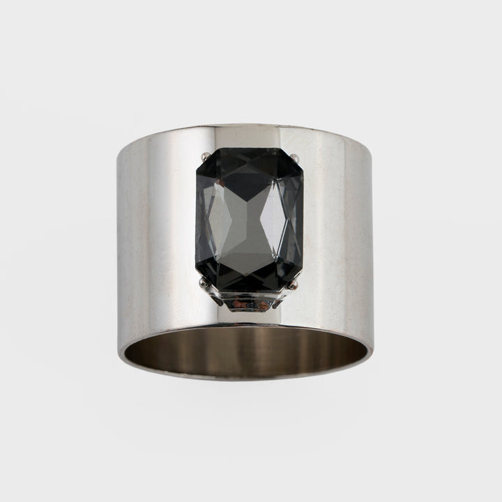 A silver napkin ring with a dark gray crystal stone set in the center, against a white background.